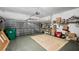 Spacious garage featuring a painted floor and a rug with extra shelving units for storage at 1673 Palace Ct, Punta Gorda, FL 33980