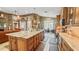 Open-concept kitchen with an oversized granite island, custom cabinetry, and stainless appliances at 1673 Palace Ct, Punta Gorda, FL 33980