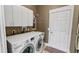 Convenient laundry room with modern washer, dryer, storage cabinets, and a utility sink at 1673 Palace Ct, Punta Gorda, FL 33980