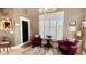 Cozy seating area with plantation shutters offering light, a small table, and elegant decor at 1673 Palace Ct, Punta Gorda, FL 33980