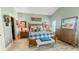 Relaxing main bedroom features wood floors, neutral paint, closet and en-suite bathroom at 1673 Palace Ct, Punta Gorda, FL 33980