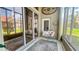 Enclosed patio featuring cushioned chairs, large windows, and sliding glass doors to the outside at 1673 Palace Ct, Punta Gorda, FL 33980