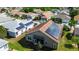 Aerial view of a home with solar panels on the roof and a well-maintained lawn at 1673 Palace Ct, Punta Gorda, FL 33980