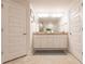 Bathroom with double vanity, granite counters, and framed mirror at 1690 Yakutat Rd, North Port, FL 34287