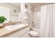 Bright bathroom featuring granite counters, framed mirror, and tub-shower combination with white shower curtain at 1690 Yakutat Rd, North Port, FL 34287