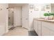 Modern bathroom with a glass shower enclosure, vanity, and tiled flooring at 1690 Yakutat Rd, North Port, FL 34287
