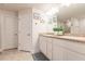 Bathroom featuring a double vanity, granite counters, framed mirror and tiled floors at 1690 Yakutat Rd, North Port, FL 34287