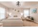Bright and airy main bedroom featuring a modern ceiling fan, beach-themed wall art, and a calming neutral color palette at 1690 Yakutat Rd, North Port, FL 34287