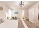 Bright bedroom featuring a ceiling fan, beachy decor, and a doorway to the bathroom at 1690 Yakutat Rd, North Port, FL 34287