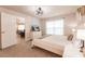 Comfortable bedroom featuring a mounted tv, plush bedding, and modern fan at 1690 Yakutat Rd, North Port, FL 34287