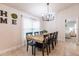 Cozy dining area with an adjoining bedroom view, stylish light fixture, and long wooden table at 1690 Yakutat Rd, North Port, FL 34287