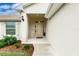 Inviting front entrance featuring a pathway, neutral colors, and manicured landscaping at 1690 Yakutat Rd, North Port, FL 34287