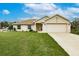 Charming single-story home with well-manicured lawn, neutral exterior, and a two-car garage at 1690 Yakutat Rd, North Port, FL 34287