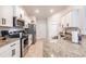 Spacious kitchen with stainless steel appliances, granite countertops and white cabinets at 1690 Yakutat Rd, North Port, FL 34287