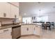 Modern kitchen featuring stainless steel appliances, granite countertops, white cabinets, and tile flooring at 1690 Yakutat Rd, North Port, FL 34287