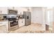 Modern kitchen featuring stainless steel appliances, granite countertops and white cabinets at 1690 Yakutat Rd, North Port, FL 34287