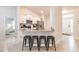 Bright kitchen featuring white cabinets, stainless steel appliances and granite countertops and a view to the front door at 1690 Yakutat Rd, North Port, FL 34287
