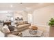 Open-concept living space with modern furnishings, neutral tones, and a view into the dining area and kitchen at 1690 Yakutat Rd, North Port, FL 34287