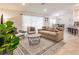 Bright living room featuring a neutral color scheme, stylish furniture, and sliding glass doors at 1690 Yakutat Rd, North Port, FL 34287
