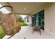 Covered patio featuring stylish seating, providing a peaceful retreat with a view of the surrounding landscape at 1690 Yakutat Rd, North Port, FL 34287