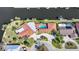 A terracotta-roofed home with a pool and circular drive, surrounded by lush landscaping at 1796 Boca Raton Ct, Punta Gorda, FL 33950