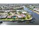 Aerial view of a waterfront home, with a swimming pool and dock, reflecting the beautiful waterfront lifestyle at 1796 Boca Raton Ct, Punta Gorda, FL 33950