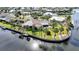 A beautiful waterfront home with a private dock, showcasing an inviting backyard along a serene canal setting at 1796 Boca Raton Ct, Punta Gorda, FL 33950