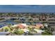 Waterfront home with terracotta roof with a spacious circular driveway and manicured landscaping at 1796 Boca Raton Ct, Punta Gorda, FL 33950