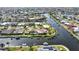 Waterfront home on a canal with a pool and dock, surrounded by lush landscaping at 1796 Boca Raton Ct, Punta Gorda, FL 33950