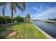 Lush green backyard with private waterway access and tropical landscaping at 1796 Boca Raton Ct, Punta Gorda, FL 33950