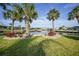 Lush backyard features manicured lawn and waterfront views, perfect for enjoying the serene canal-front setting at 1796 Boca Raton Ct, Punta Gorda, FL 33950