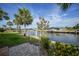 Backyard overlooking a canal, featuring well-maintained landscaping, and direct water access at 1796 Boca Raton Ct, Punta Gorda, FL 33950