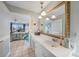 Stylish bathroom with a large mirror, vanity area, and access to a well-lit bedroom at 1796 Boca Raton Ct, Punta Gorda, FL 33950