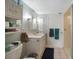 Cozy bathroom featuring a single vanity, tiled shower, and convenient storage options at 1796 Boca Raton Ct, Punta Gorda, FL 33950