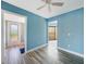 Bedroom featuring a ceiling fan and tile flooring with a connecting doorway to outside at 1796 Boca Raton Ct, Punta Gorda, FL 33950