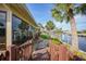 Beautiful home with lush landscaping, a paver walkway, and waterfront views creating a tranquil setting at 1796 Boca Raton Ct, Punta Gorda, FL 33950