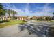Spacious one-story home with lush front lawn, circular driveway, and attached garage under a bright blue sky at 1796 Boca Raton Ct, Punta Gorda, FL 33950