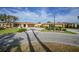 Charming single story home with well-manicured lawn, mature palms, and a circular driveway at 1796 Boca Raton Ct, Punta Gorda, FL 33950