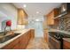 Kitchen with wood cabinets and stainless steel appliances at 1796 Boca Raton Ct, Punta Gorda, FL 33950