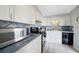 Cozy kitchen features white cabinetry, blue backsplash, and essential appliances, offering functionality in a compact space at 1796 Boca Raton Ct, Punta Gorda, FL 33950