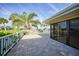 Covered patio with pavers, white railing, and sliding glass doors to inside at 1796 Boca Raton Ct, Punta Gorda, FL 33950
