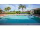 Relaxing in-ground pool with brick surround, landscaping, and clear blue water in a backyard setting at 1796 Boca Raton Ct, Punta Gorda, FL 33950