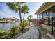 Beautiful waterfront home featuring a private dock, lush landscaping, and charming walkway at 1796 Boca Raton Ct, Punta Gorda, FL 33950