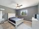 Neutrally decorated bedroom with a large ceiling fan and natural light from a window at 18151 Cochran Blvd, Port Charlotte, FL 33948