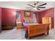 Bedroom with wood-look floors, a ceiling fan, and natural light from the dual windows at 18151 Cochran Blvd, Port Charlotte, FL 33948