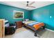 Bedroom with a large window, dark leather recliner, and ceiling fan at 18151 Cochran Blvd, Port Charlotte, FL 33948
