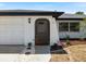 Inviting front entrance with decorative stone and landscaping, plus an attached garage at 18151 Cochran Blvd, Port Charlotte, FL 33948