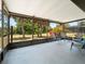 Screened lanai offers a relaxing outdoor space with seating and views of the lush backyard at 18151 Cochran Blvd, Port Charlotte, FL 33948