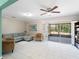 Spacious living room featuring tile floors, modern furniture, and sliding doors to an enclosed outdoor space at 18151 Cochran Blvd, Port Charlotte, FL 33948