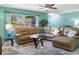 Spacious living room featuring an oversized sectional sofa and natural light at 18151 Cochran Blvd, Port Charlotte, FL 33948